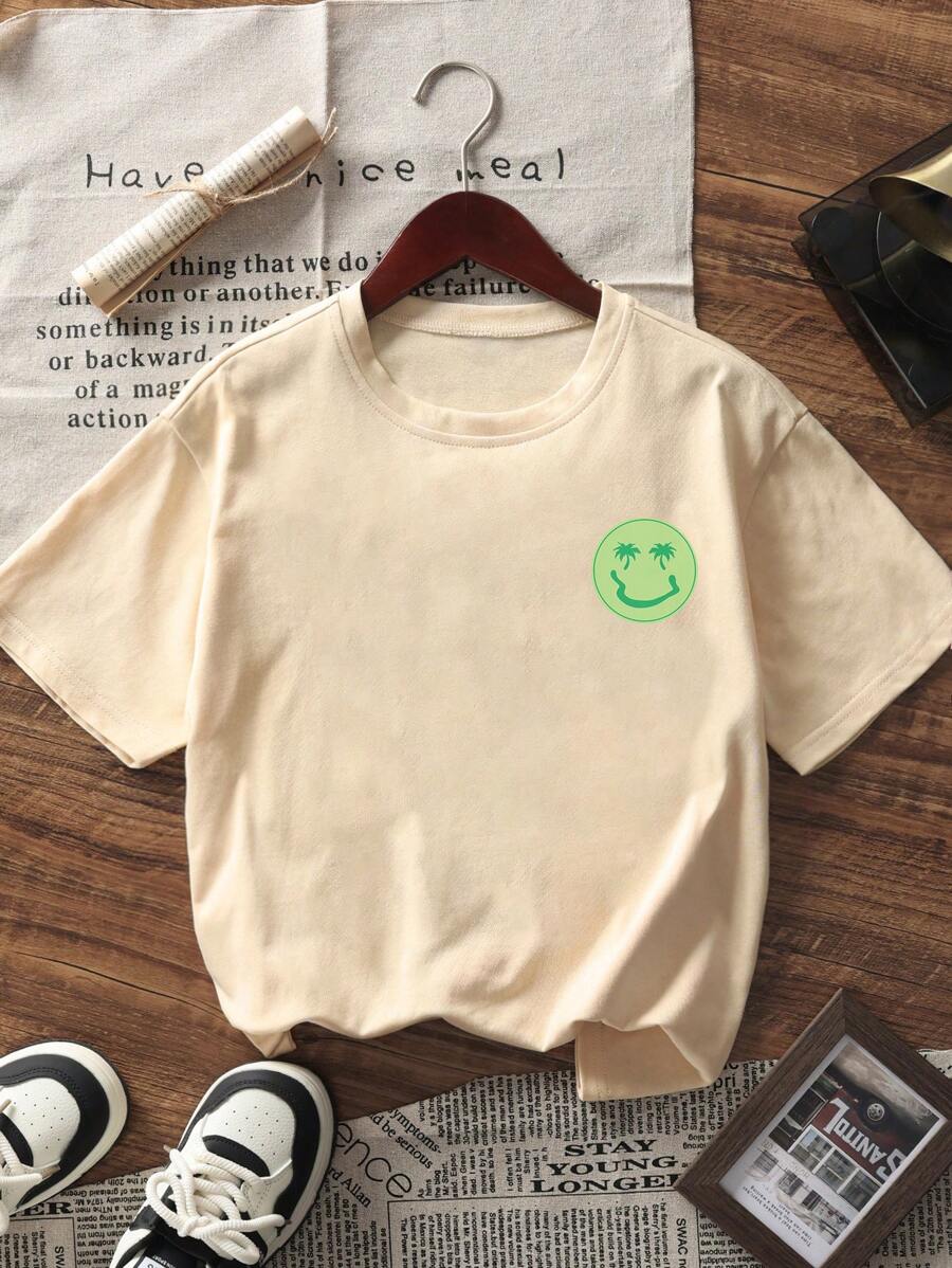 Camiseta de manga corta con estampado de palmera y cara sonriente para niño preadolescente, ideal para jugar en la playa.