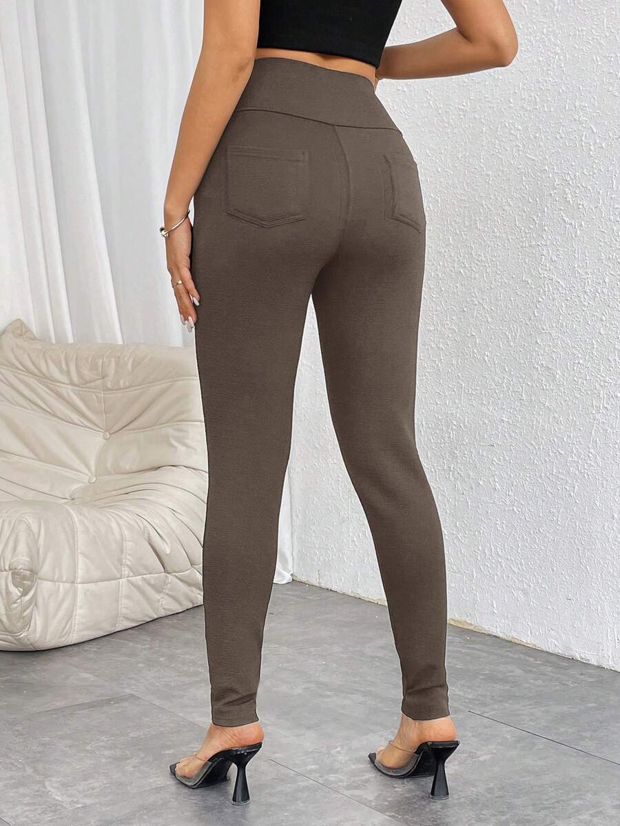 Pantalones casuales ajustados de cintura alta con cremallera y botones frontales de color liso para mujer de Firerie